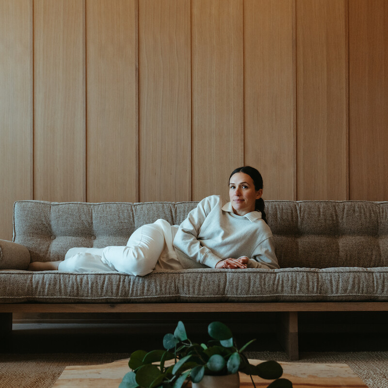 Adriene Mishler lying down on couch.