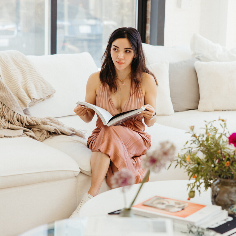 Amanda Gunawan reading on couch.