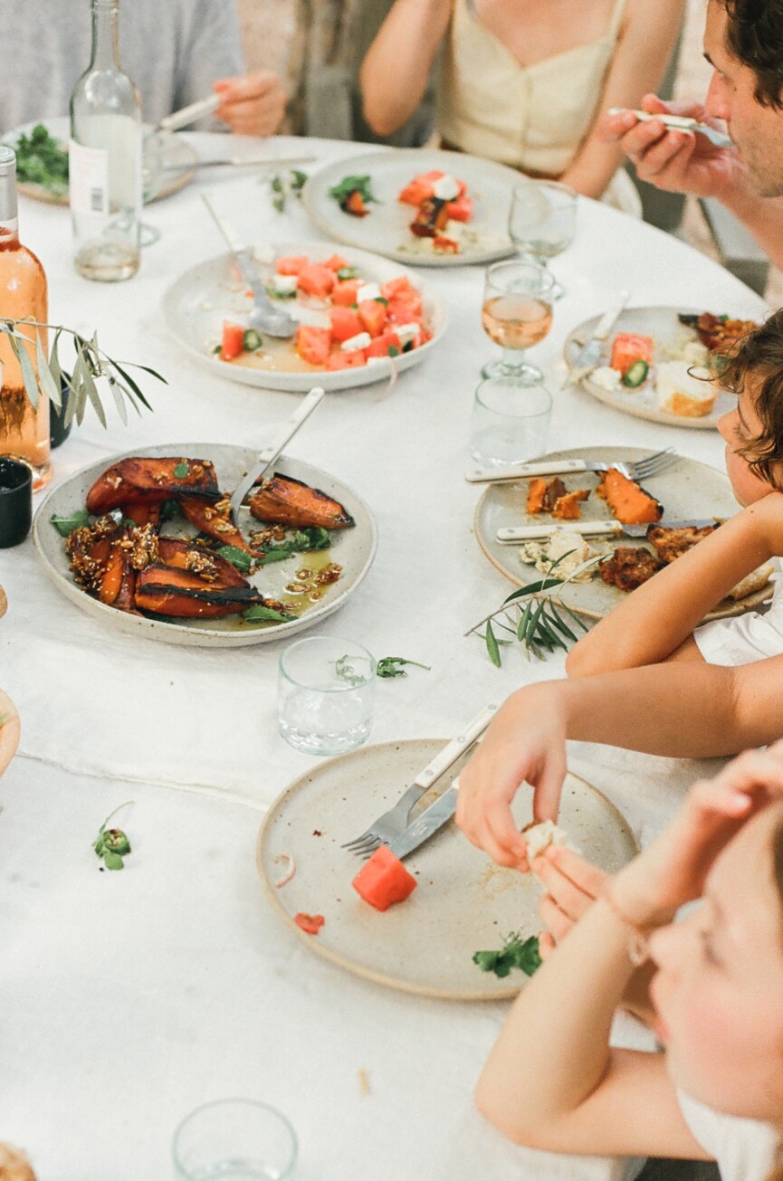 dinner party table with charred sweet potatoes