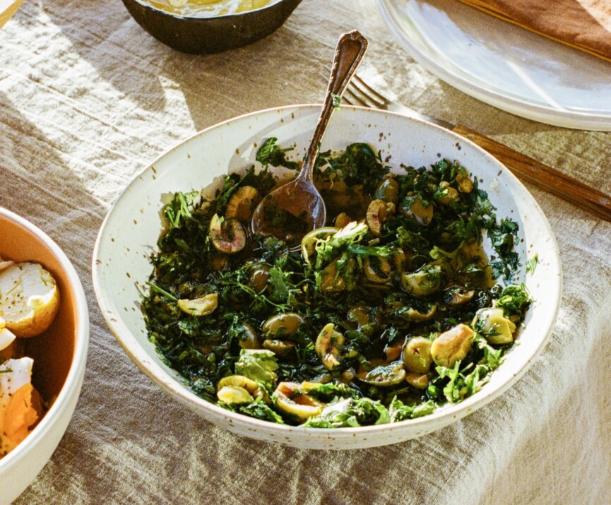 White bowl on table filled with Italian salsa verde.