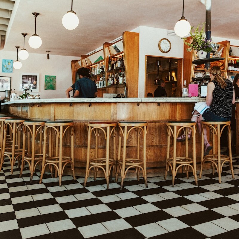 Woman sits at a countertop at Junes All Day in Austin, Texas. Part of our Guide to the Best Brunch in Austin.