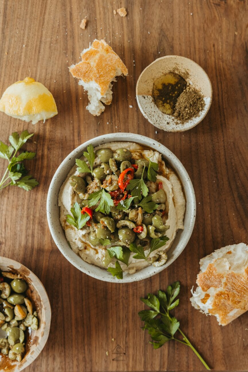 marinated olives with hummus in a bowl