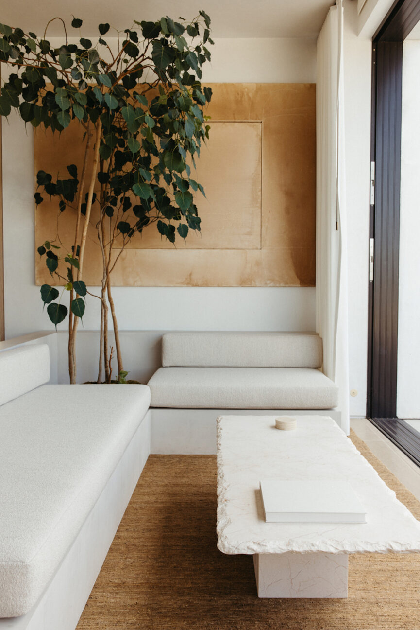 Minimalist white couches in living room.