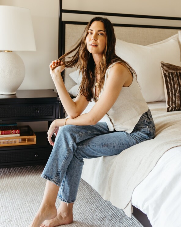 woman sitting on a bed