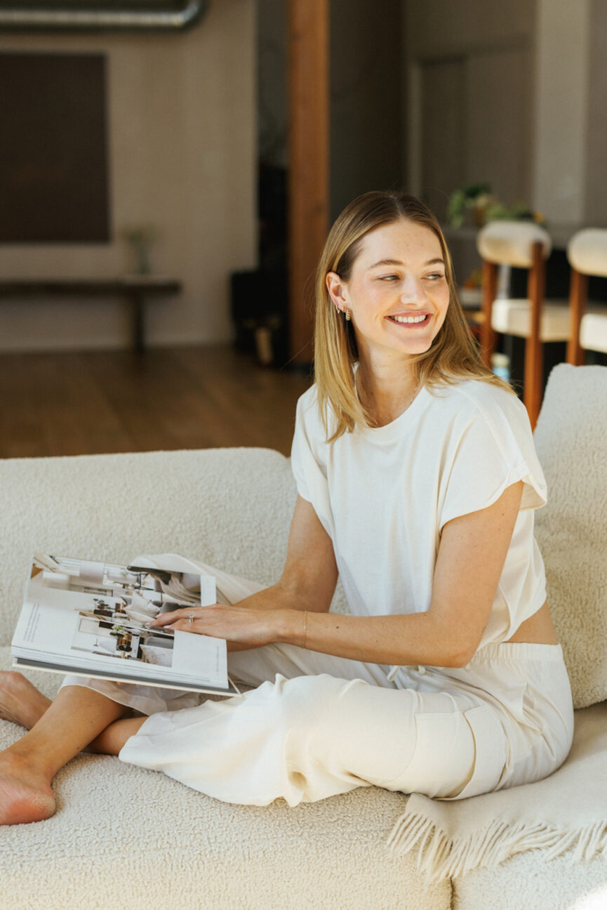 Woman reading on couch about social media boudaries.