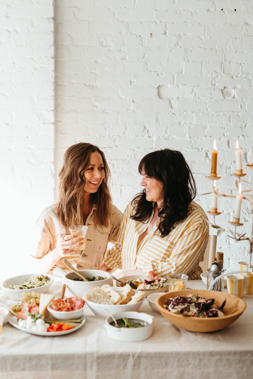 Women smiling at dinner table.